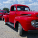 A ~1950 Ford F1 pickup in front of a 2018 F-150.